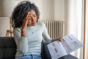 Young woman struggling with basic financial needs, such as how to pay for the energy bill